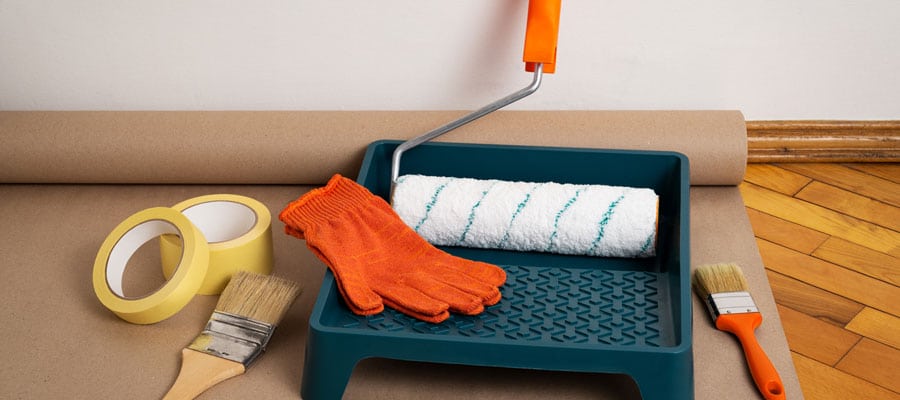 Painting Tools and Supplies Painting tools and supplies on floor.